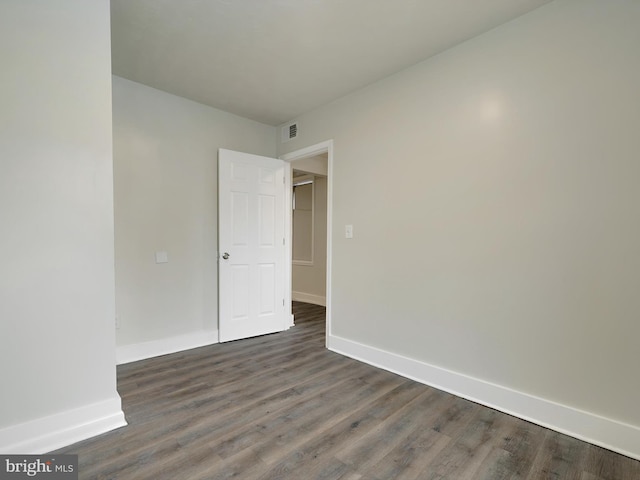 empty room featuring dark wood-type flooring