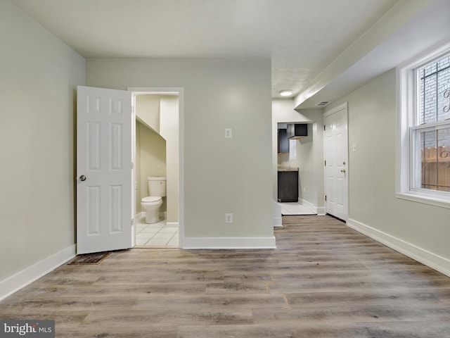 spare room with light hardwood / wood-style floors and a wealth of natural light