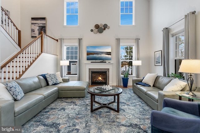 living room featuring a towering ceiling and hardwood / wood-style floors