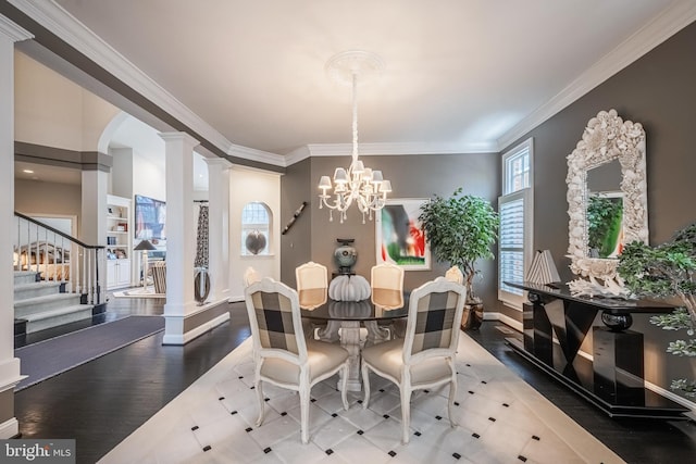 dining room featuring decorative columns, crown molding, and a chandelier