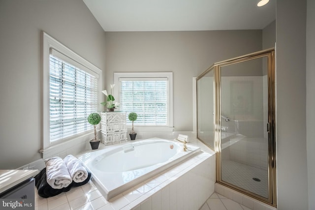 bathroom with vanity, tile patterned floors, and plus walk in shower