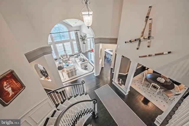 interior space featuring a high ceiling and dark hardwood / wood-style flooring