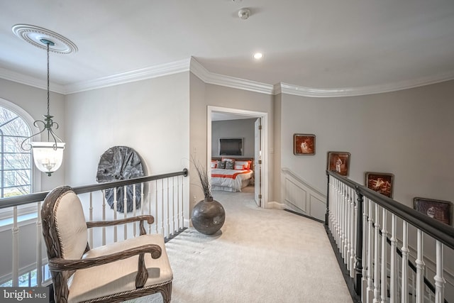 sitting room featuring crown molding, light carpet, and a notable chandelier