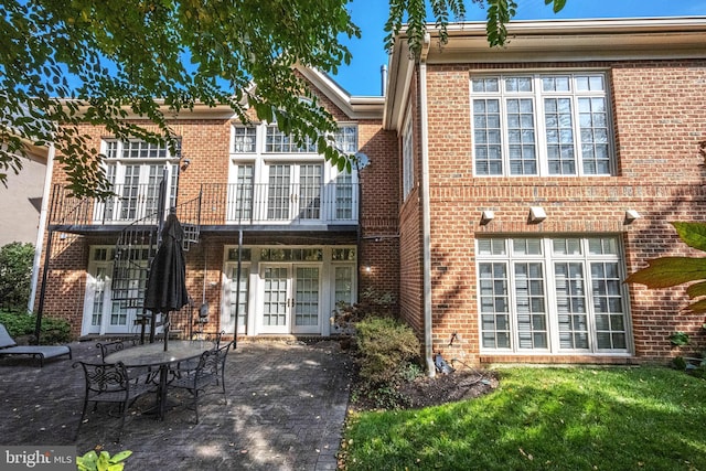 back of property with a patio