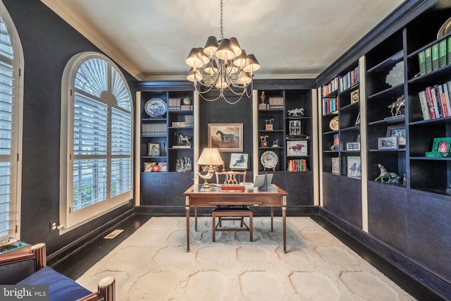 office space featuring ornamental molding, built in features, and an inviting chandelier