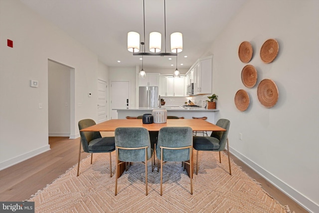 dining space with light wood-type flooring