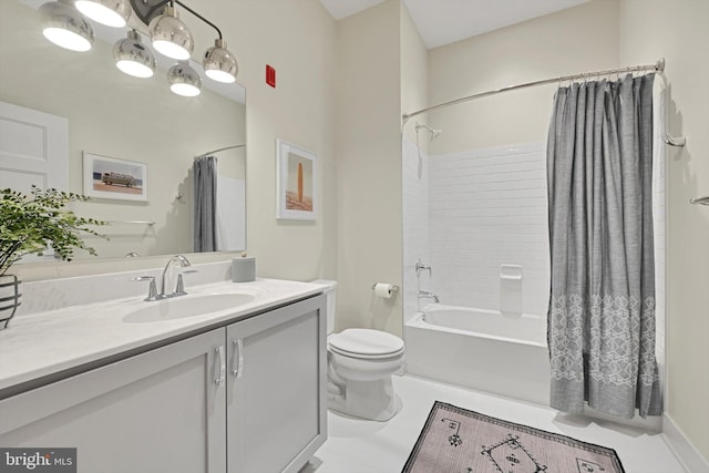 full bathroom featuring shower / bath combo with shower curtain, tile patterned floors, vanity, and toilet