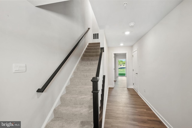 stairway with hardwood / wood-style floors