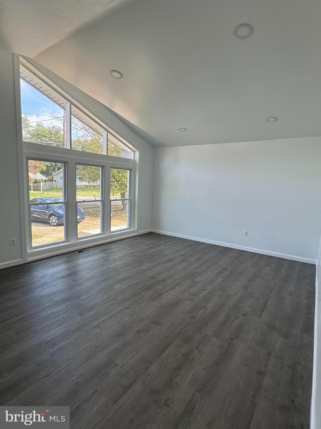 unfurnished room with vaulted ceiling