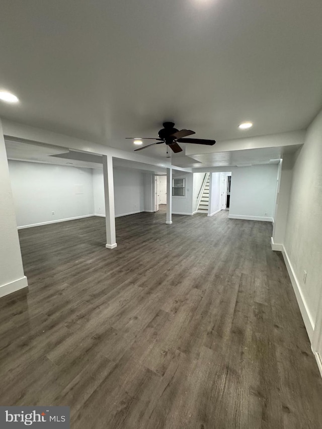 basement with dark hardwood / wood-style flooring and ceiling fan