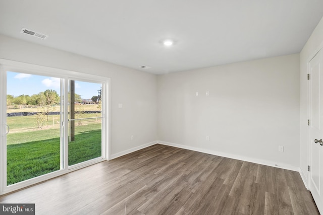 spare room with wood-type flooring