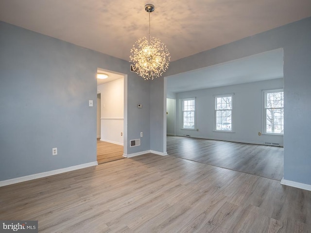 interior space featuring a chandelier and light hardwood / wood-style flooring