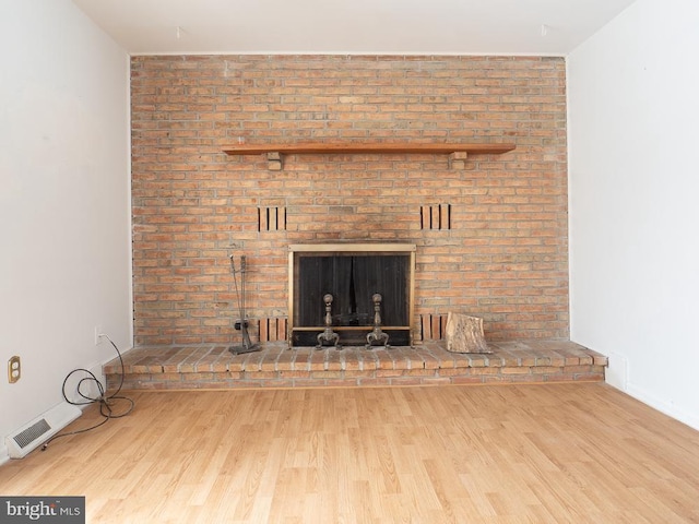 interior details with a fireplace and hardwood / wood-style flooring