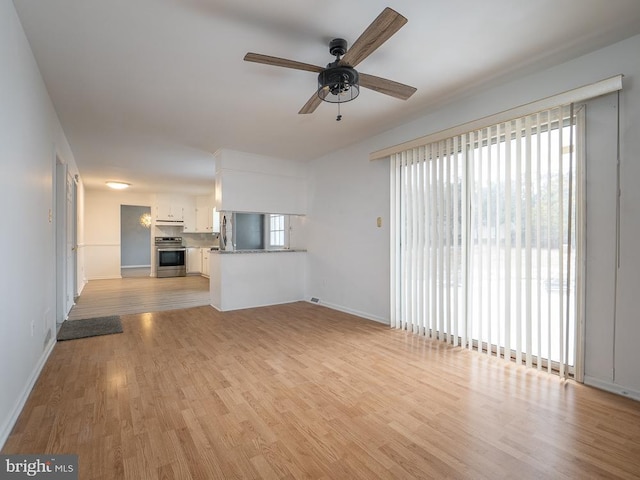 unfurnished living room with ceiling fan and light hardwood / wood-style floors