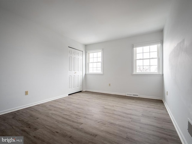 spare room with hardwood / wood-style floors