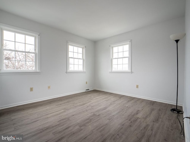 empty room with hardwood / wood-style floors