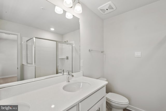 bathroom featuring toilet, an enclosed shower, and vanity