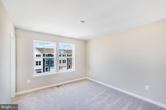 empty room featuring light carpet