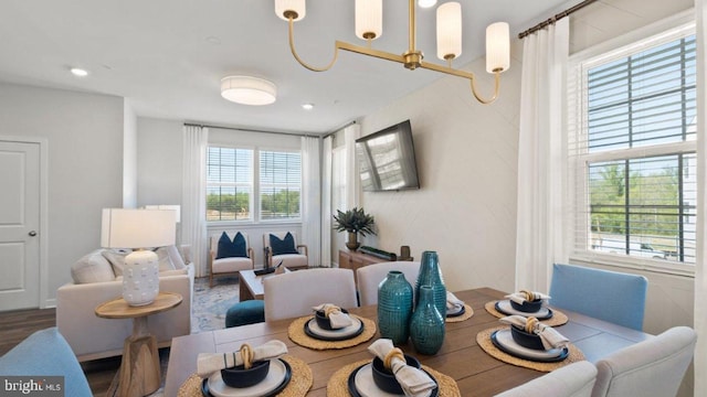 dining room featuring wood-type flooring and a chandelier