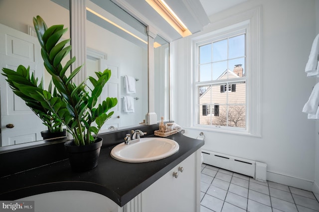 bathroom featuring a baseboard radiator, vanity, baseboards, and tile patterned floors