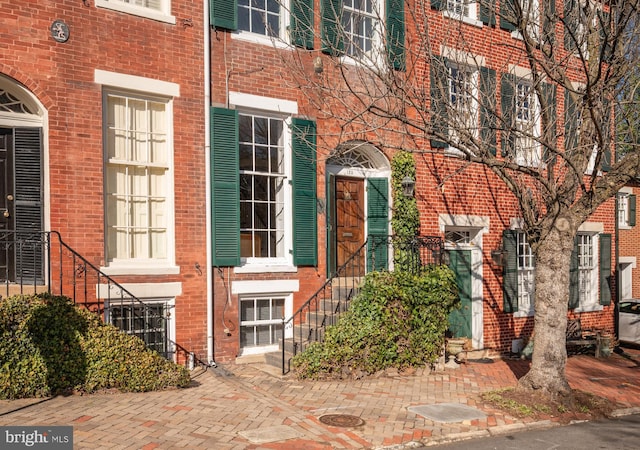 entrance to property featuring central air condition unit and brick siding