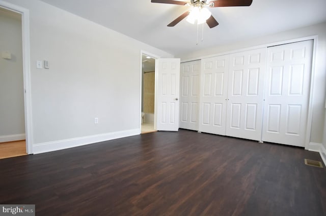 unfurnished bedroom featuring ceiling fan and dark hardwood / wood-style flooring