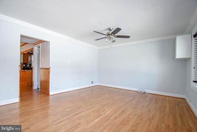 unfurnished room featuring ornamental molding, ceiling fan, and light wood-type flooring