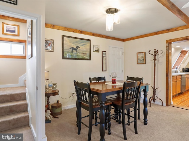 dining space featuring light colored carpet