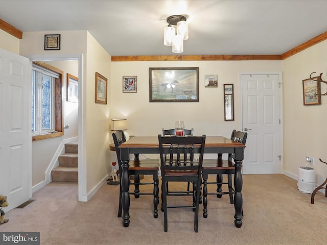 dining space featuring light carpet