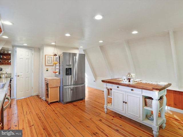 kitchen with stainless steel refrigerator with ice dispenser and light wood-type flooring