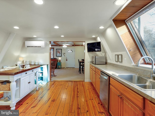 kitchen featuring sink, a wall mounted air conditioner, wooden counters, light wood-type flooring, and dishwasher