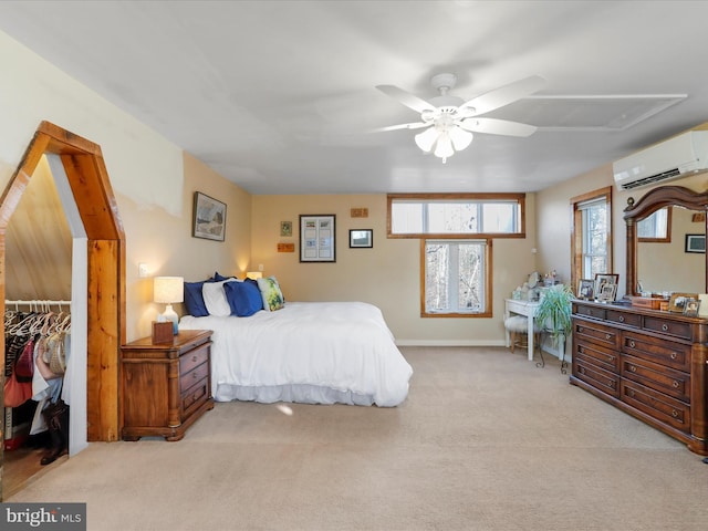 carpeted bedroom with ceiling fan, a wall unit AC, and a closet