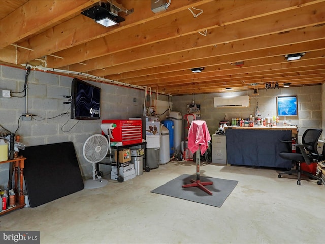 basement with electric water heater and a wall mounted AC