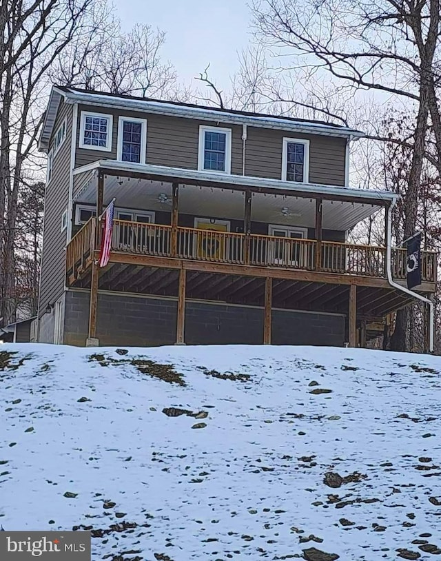 view of snow covered rear of property