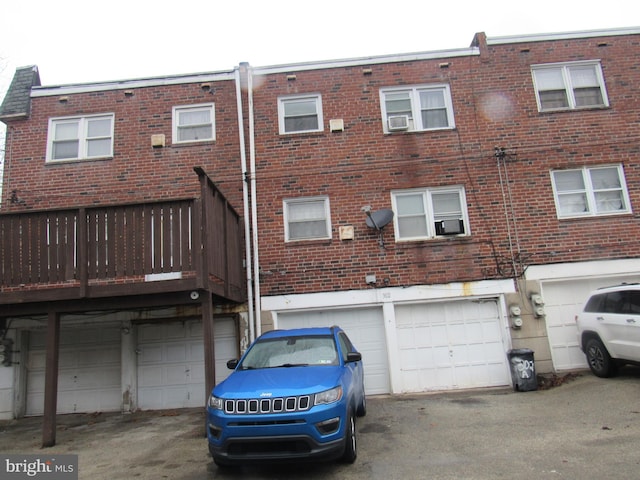 rear view of house with a garage