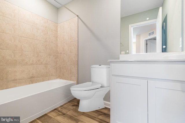 full bathroom with toilet, vanity, tub / shower combination, and hardwood / wood-style flooring