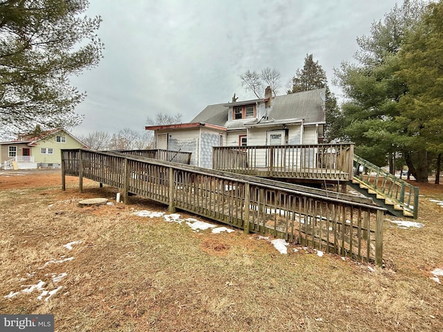 back of house with a wooden deck