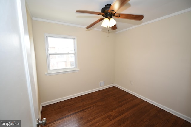 empty room with ceiling fan, dark hardwood / wood-style flooring, and crown molding