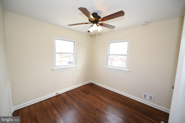 unfurnished room with ceiling fan and dark wood-type flooring