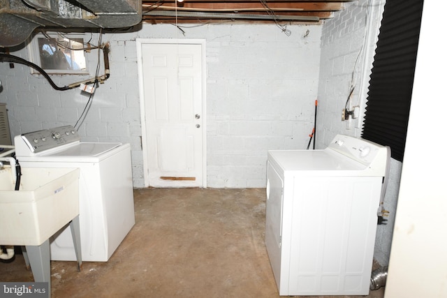 clothes washing area featuring sink and washing machine and clothes dryer