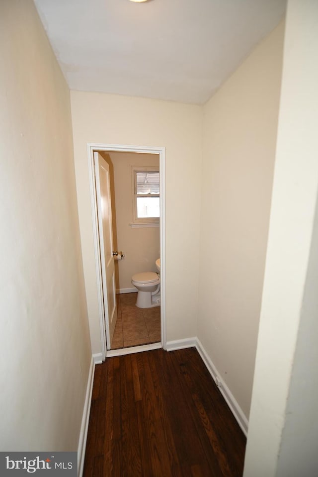 hallway featuring dark hardwood / wood-style flooring