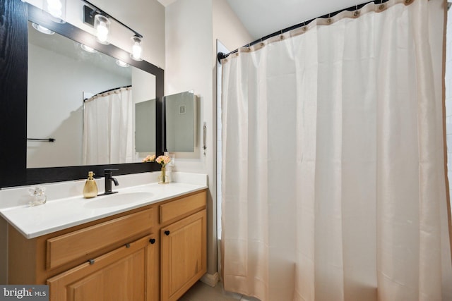 bathroom featuring vanity and walk in shower