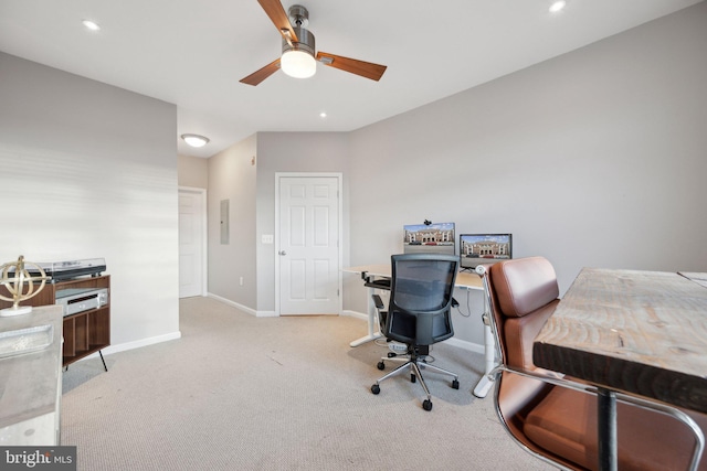 office space featuring light carpet, electric panel, and ceiling fan