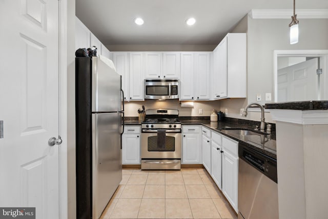 kitchen with sink, white cabinetry, decorative light fixtures, light tile patterned floors, and appliances with stainless steel finishes