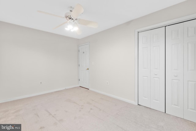 unfurnished bedroom featuring ceiling fan and light colored carpet