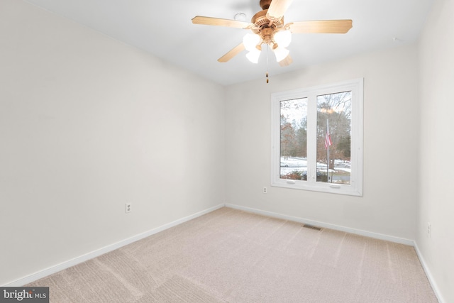 empty room featuring light carpet and ceiling fan