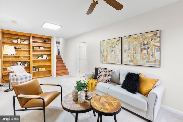 carpeted living room with ceiling fan and built in features