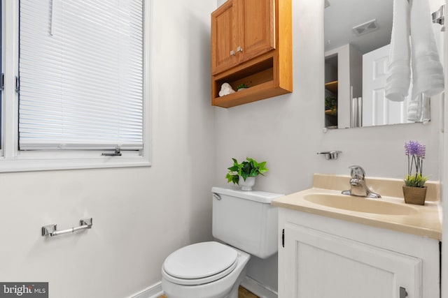 bathroom featuring toilet and vanity