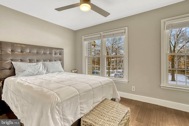 bedroom with ceiling fan and dark wood-type flooring