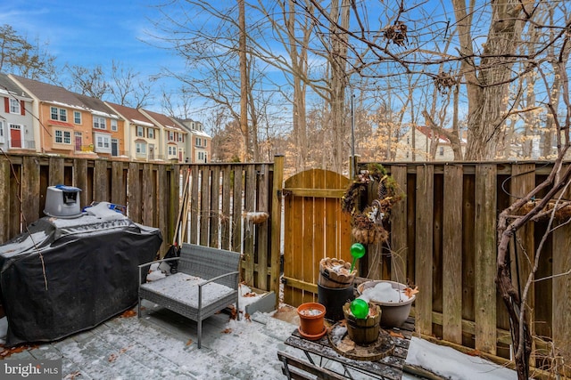 snow covered patio featuring a grill